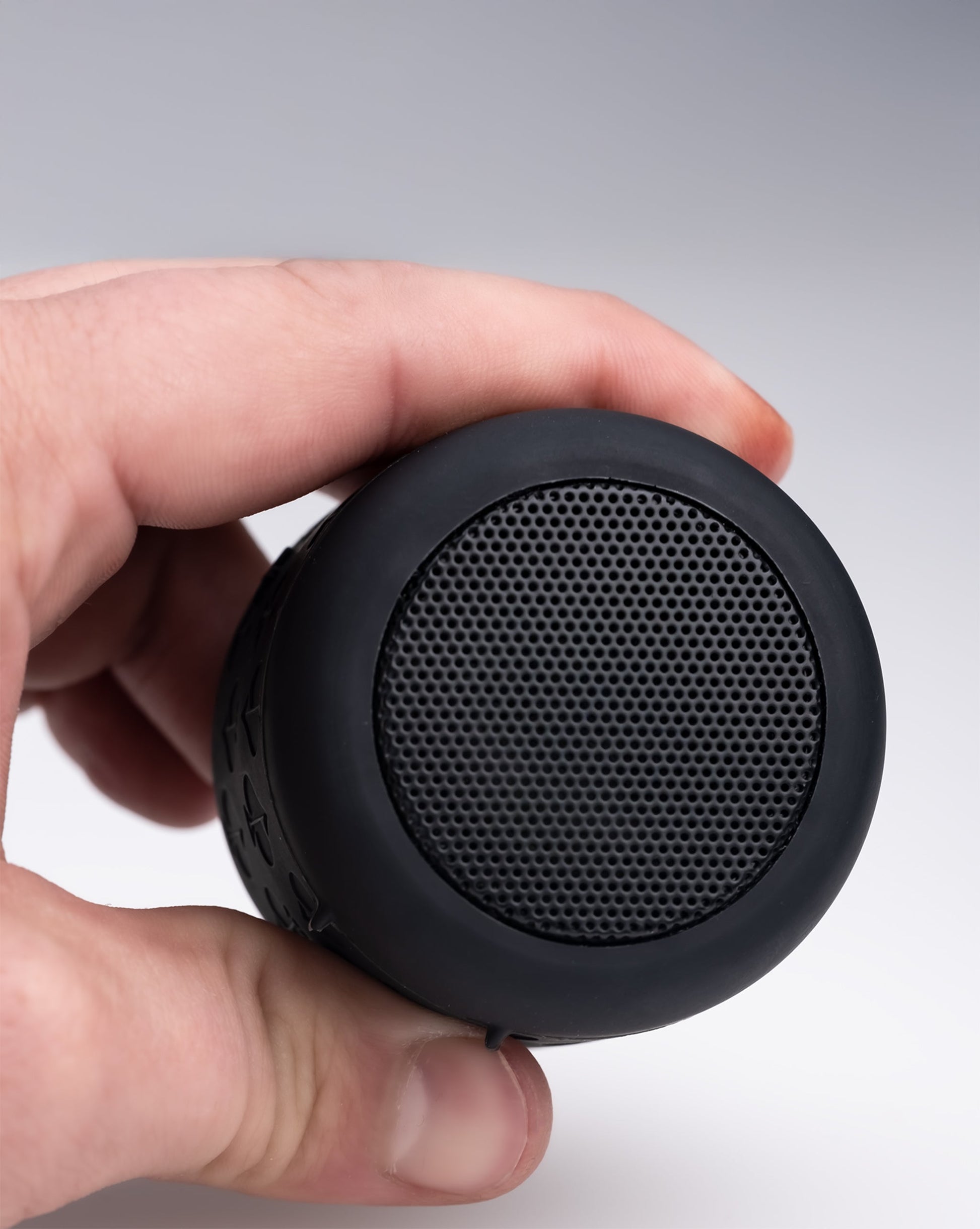 Spade Speaker in a modern living room setting, featuring a sleek design with a wood finish and stylish contours.