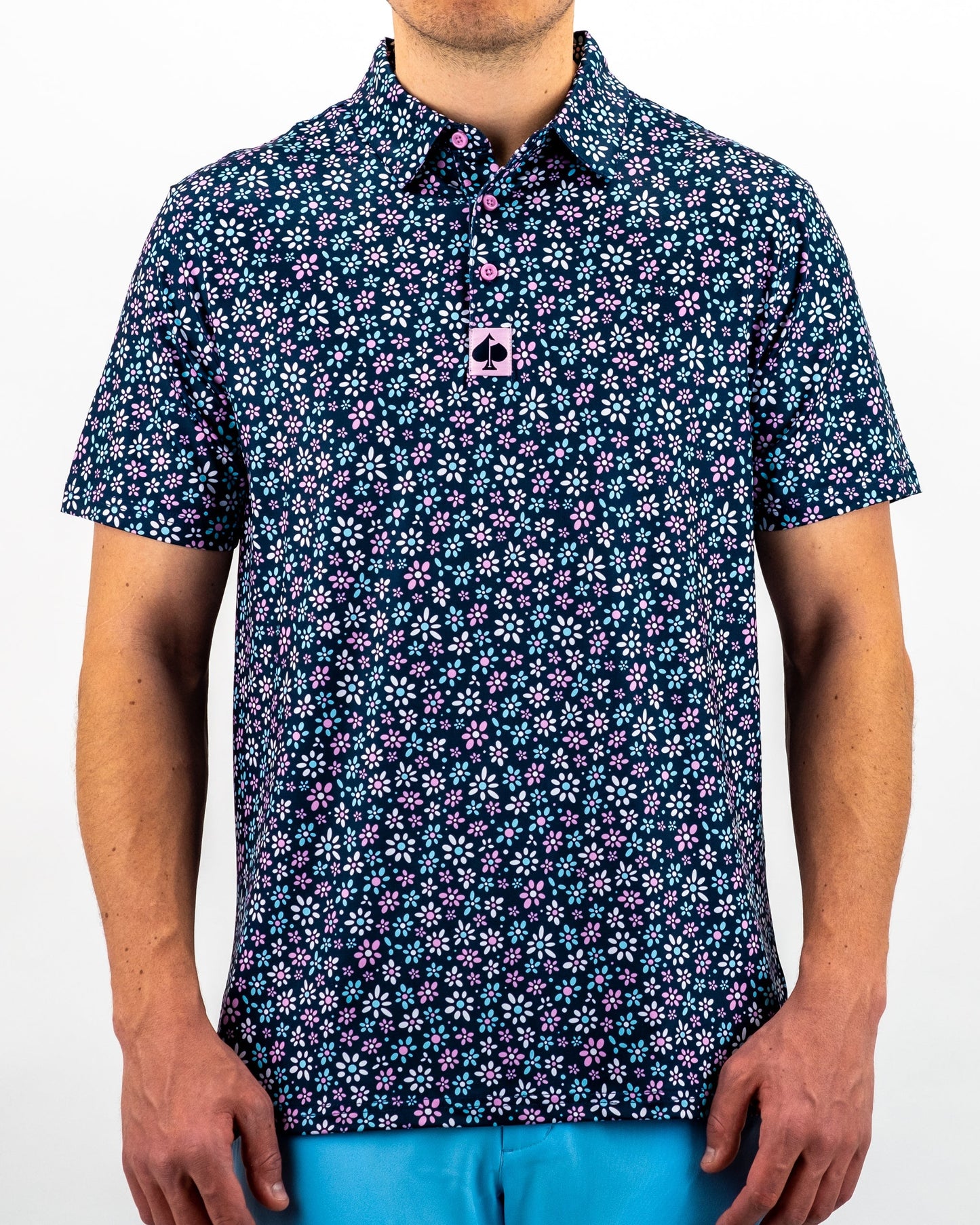 "Daisy Daze floral print dress with short sleeves and a cinched waist, featuring a vibrant daisy pattern on a light background."