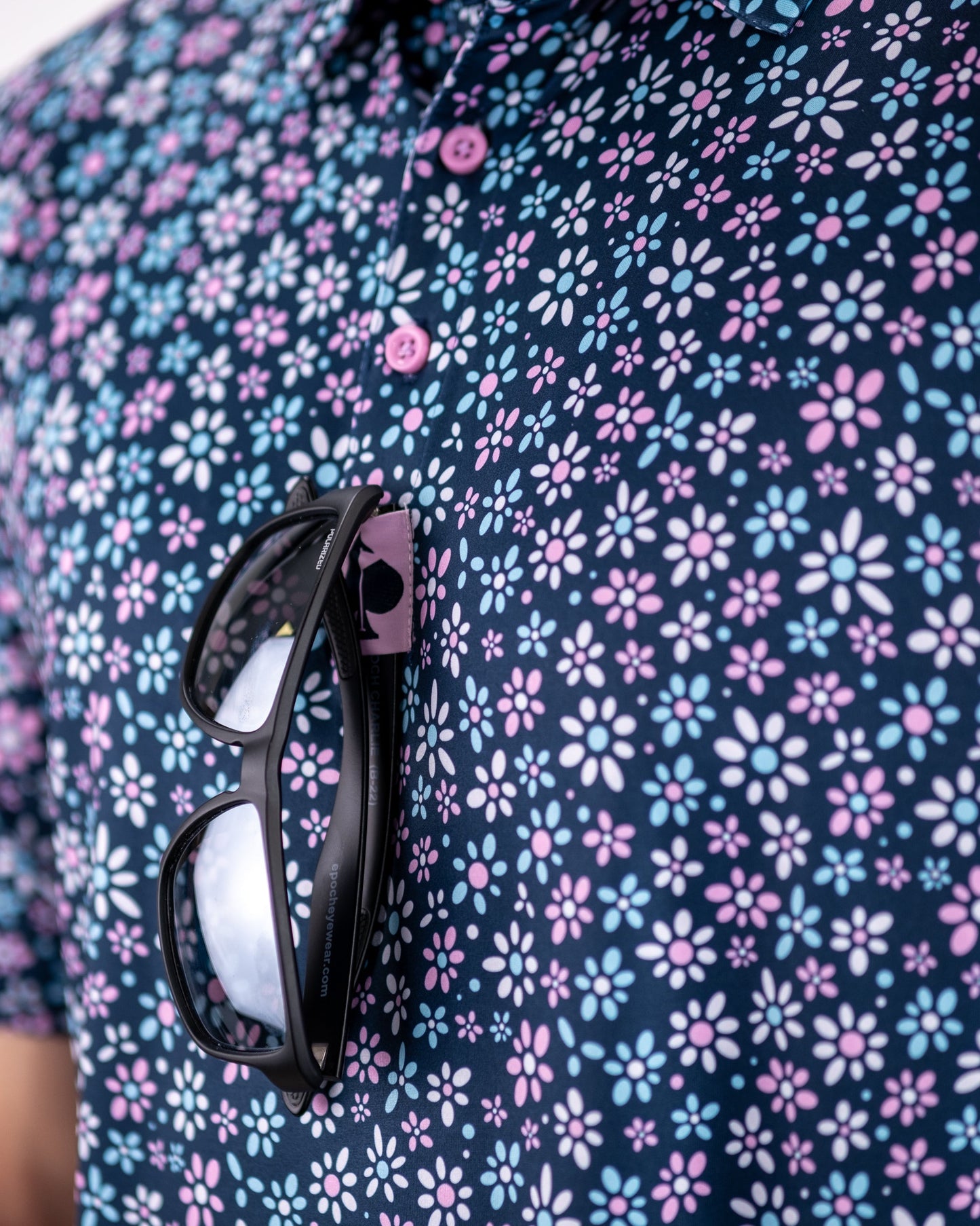 Colorful daisy-patterned dress on a mannequin, featuring a fitted bodice and flared skirt.