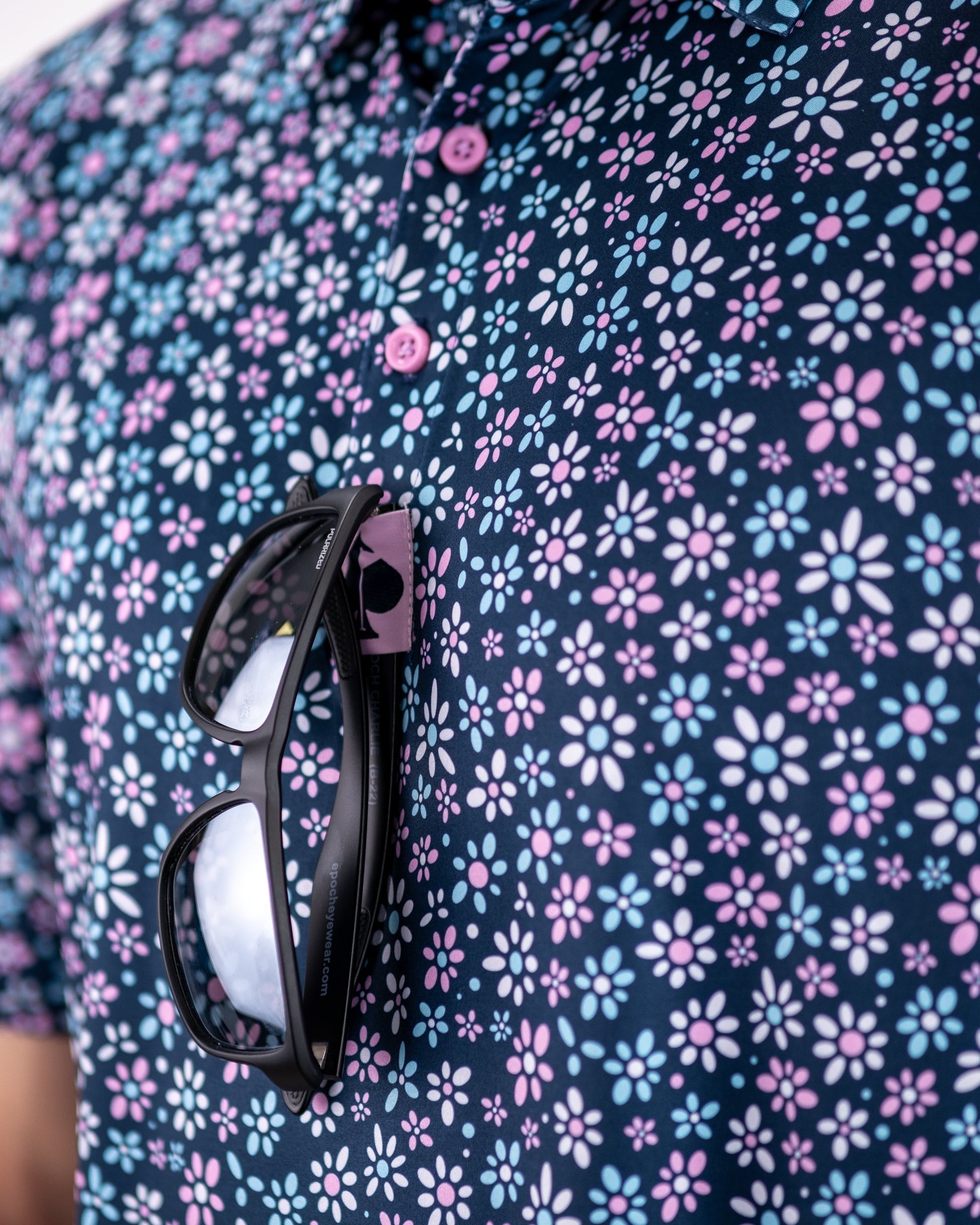 Colorful daisy-patterned dress on a mannequin, featuring a fitted bodice and flared skirt.