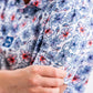 Hibiscus Harmony men's shirt featuring a vibrant hibiscus print on a light background.