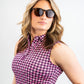 Women's houndstooth patterned dress in raspberry color, featuring a fitted silhouette and short sleeves.