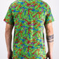 TMNT Mean Green polo shirt featuring colorful turtle head designs on a vibrant green background.