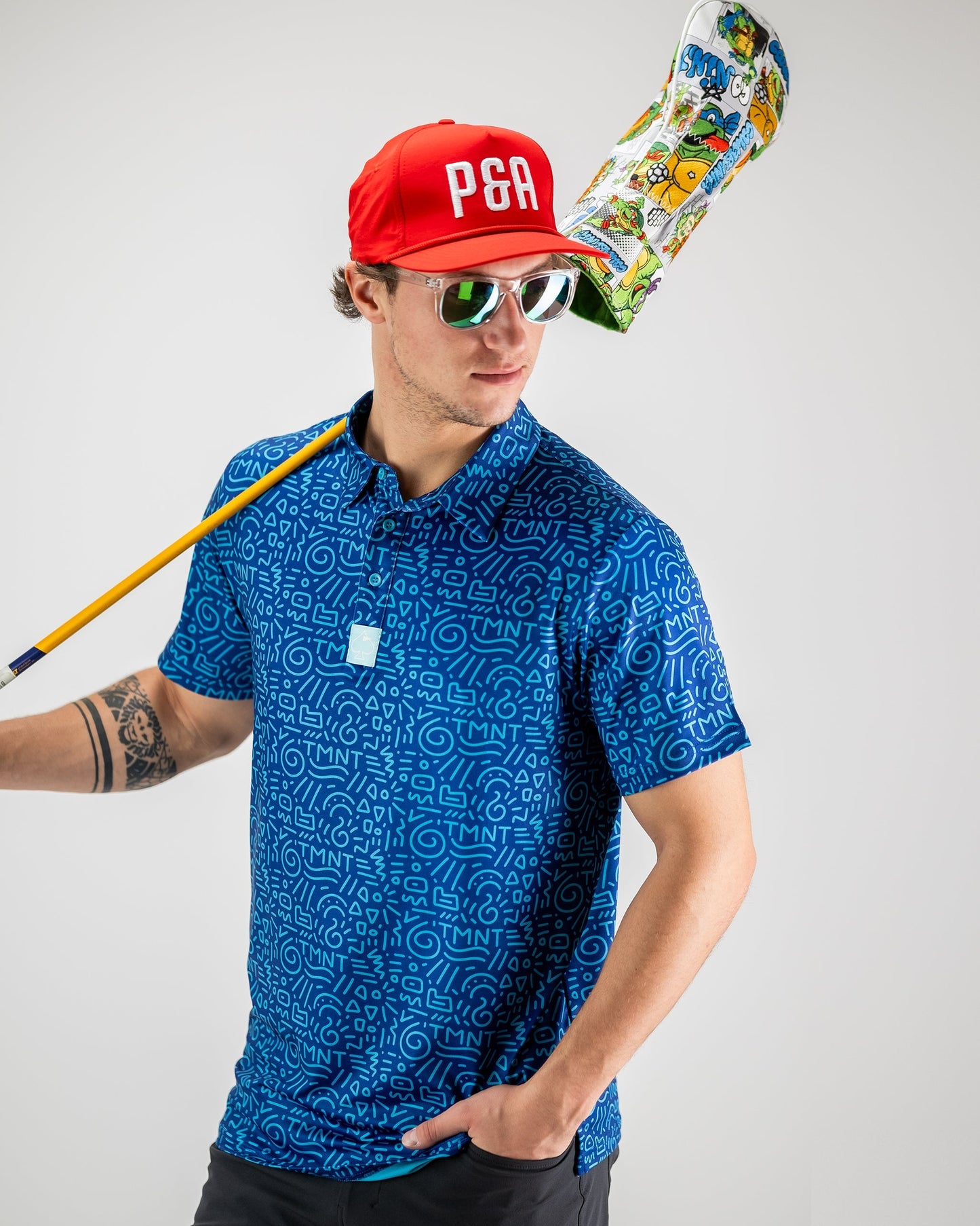 TMNT Doodle graphic featuring the Teenage Mutant Ninja Turtles in a colorful, artistic style on a polo shirt design.