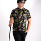 TMNT Turtle Flower Power polo shirt featuring colorful turtle graphics and floral designs on a vibrant background.