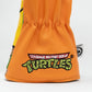 TMNT Michelangelo driver cover featuring a vibrant orange color and playful design, showcasing the character's face with a signature bandana and expressive eyes.