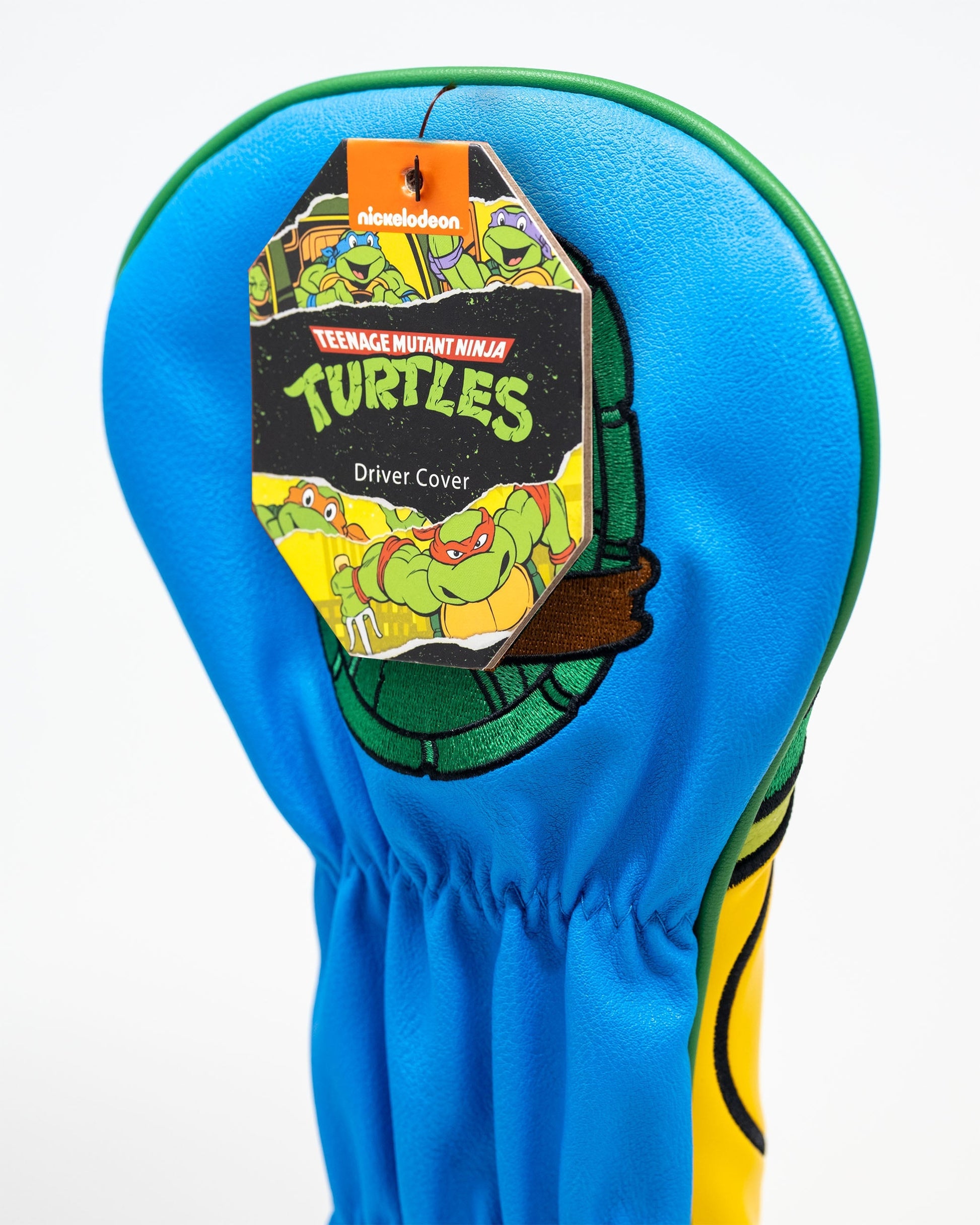 TMNT Leonardo driver cover featuring vibrant blue and green colors with a cartoon design of Leonardo, the Teenage Mutant Ninja Turtle, holding his sword.