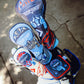 Set of four Top Gun Maverick themed golf club headcovers featuring fighter pilot helmet designs in red, white, blue, and black colors.