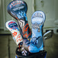 Set of three Top Gun Maverick themed golf club blade headcovers with skull and pilot helmet designs in black, white, and blue colors.