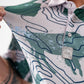 Yellowstone Topographic map design on apparel, featuring detailed terrain lines and landmark highlights.
