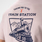 Yellowstone Train Station Tee featuring a vintage-style design with the iconic Yellowstone National Park logo in a distressed finish on a soft fabric.