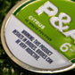Close-up of a 6 Milly Citrus Ball Marker, featuring a warning about its addictive nature for birdie enthusiasts.