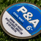 Close-up of a 6 Milly Cool Mint ball marker featuring a blue and silver design with warning label.
