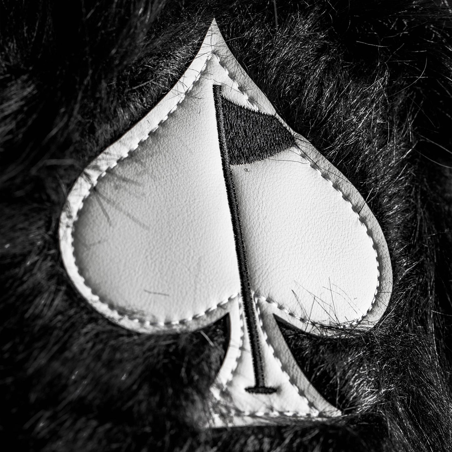Black fuzzy driver cover for golf clubs with a stylish and soft design.